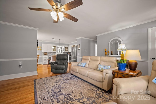 136 Coventry Ln, Forest City, NC 28043 - living room with ceiling fan, light wood finished floors, baseboards, and ornamental molding