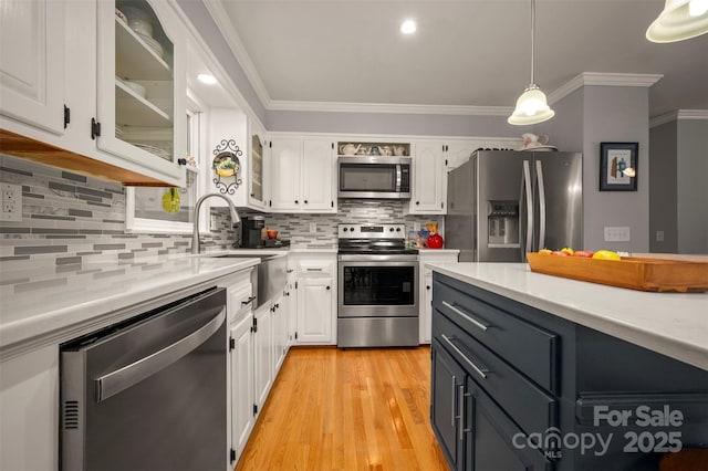 136 Coventry Ln, Forest City, NC 28043 - kitchen with appliances with stainless steel finishes, white cabinetry, light countertops, and crown molding