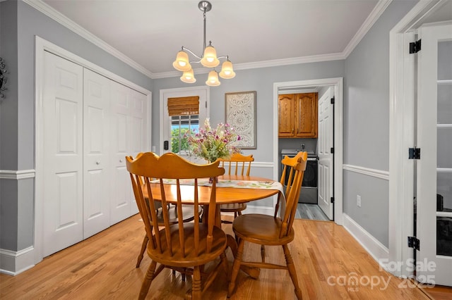 136 Coventry Ln, Forest City, NC 28043 - dining room featuring a chandelier, light wood-type flooring, ornamental molding, and baseboards