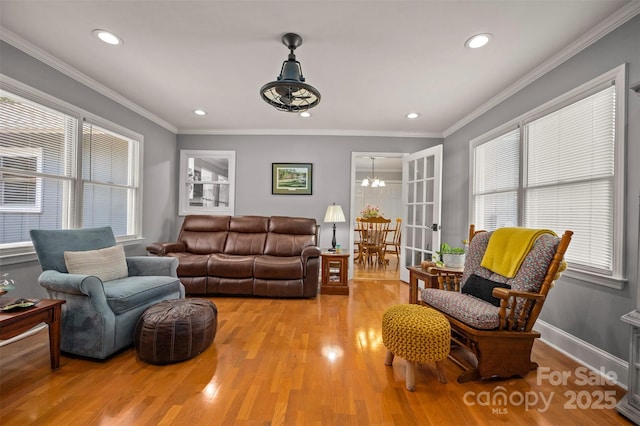 136 Coventry Ln, Forest City, NC 28043 - living room featuring light wood-type flooring, a chandelier, recessed lighting, and ornamental molding