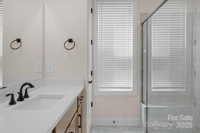 7332 Jolly Brook Dr, Charlotte, NC 28215 - bathroom featuring vanity, baseboards, a shower with door, and tile patterned flooring