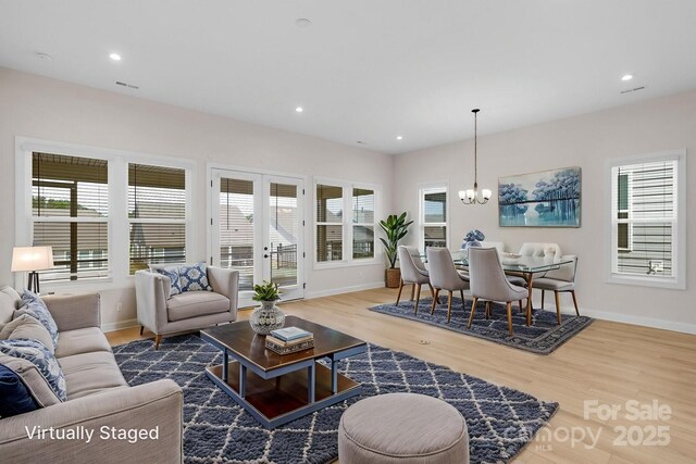 7332 Jolly Brook Dr, Charlotte, NC 28215 - living area with wood finished floors, baseboards, a chandelier, and recessed lighting
