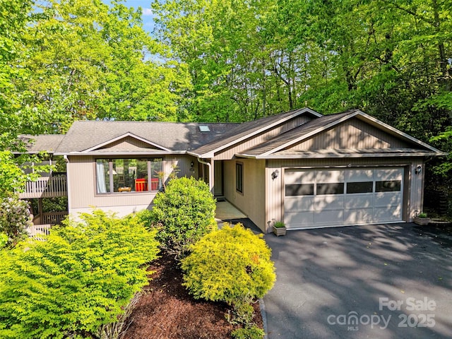 single story home featuring a garage and driveway