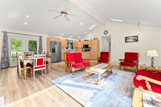 living area with beamed ceiling, light wood-style flooring, french doors, ceiling fan, and recessed lighting