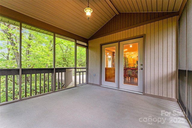 unfurnished sunroom featuring lofted ceiling