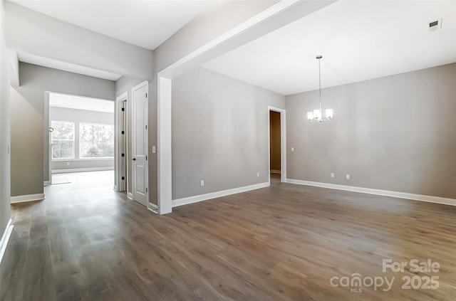 7517 Lancaster Hwy Unit 5, Waxhaw, NC 28173 - spare room with a chandelier, dark wood finished floors, and baseboards