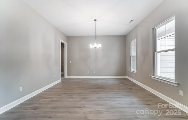 7517 Lancaster Hwy Unit 5, Waxhaw, NC 28173 - unfurnished dining area featuring a chandelier, wood finished floors, and baseboards