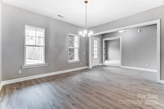 7517 Lancaster Hwy Unit 5, Waxhaw, NC 28173 - unfurnished dining area with a chandelier, wood finished floors, healthy amount of natural light, and baseboards