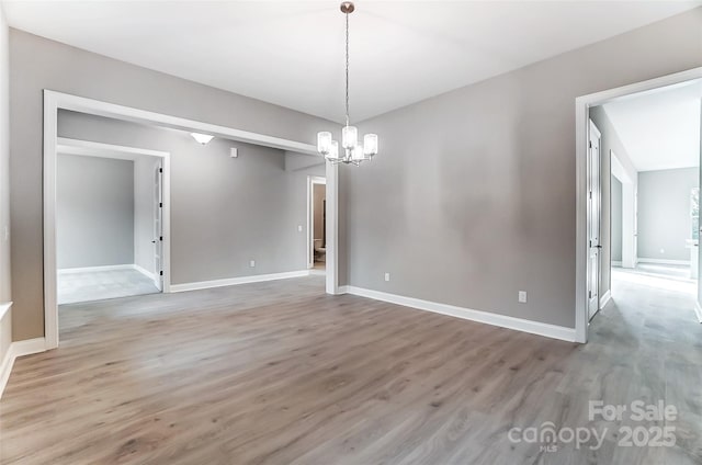 7517 Lancaster Hwy Unit 5, Waxhaw, NC 28173 - spare room featuring a chandelier, light wood-type flooring, and baseboards