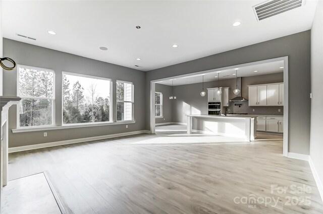 7517 Lancaster Hwy Unit 5, Waxhaw, NC 28173 - unfurnished living room with baseboards, light wood finished floors, and recessed lighting