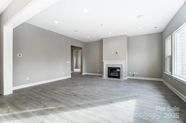 7517 Lancaster Hwy Unit 5, Waxhaw, NC 28173 - unfurnished living room featuring wood finished floors, a high end fireplace, baseboards, and recessed lighting