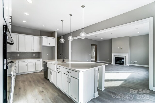 7517 Lancaster Hwy Unit 5, Waxhaw, NC 28173 - kitchen featuring light wood-style flooring, tasteful backsplash, recessed lighting, white cabinetry, and decorative light fixtures
