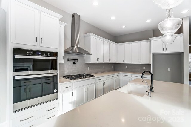 7517 Lancaster Hwy Unit 5, Waxhaw, NC 28173 - kitchen featuring wall chimney exhaust hood, a sink, appliances with stainless steel finishes, backsplash, and recessed lighting