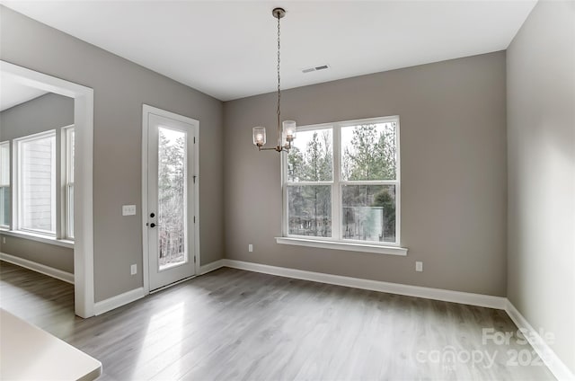 7517 Lancaster Hwy Unit 5, Waxhaw, NC 28173 - unfurnished dining area with wood finished floors, a chandelier, and baseboards
