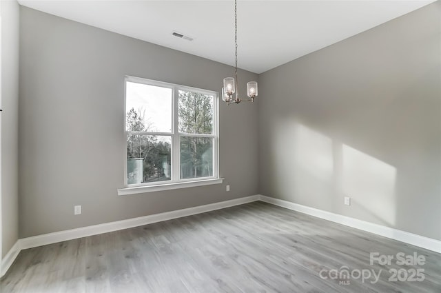 7517 Lancaster Hwy Unit 5, Waxhaw, NC 28173 - spare room featuring wood finished floors, a chandelier, and baseboards