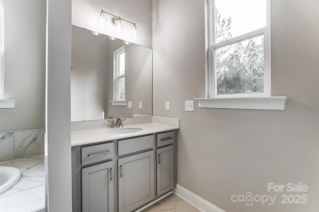 7517 Lancaster Hwy Unit 5, Waxhaw, NC 28173 - bathroom featuring marble finish flooring, vanity, a bathtub, and baseboards