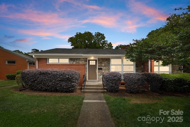 4226 Randolph Rd, Charlotte, NC 28211 - view of front of home featuring a front lawn, stone siding, and brick siding