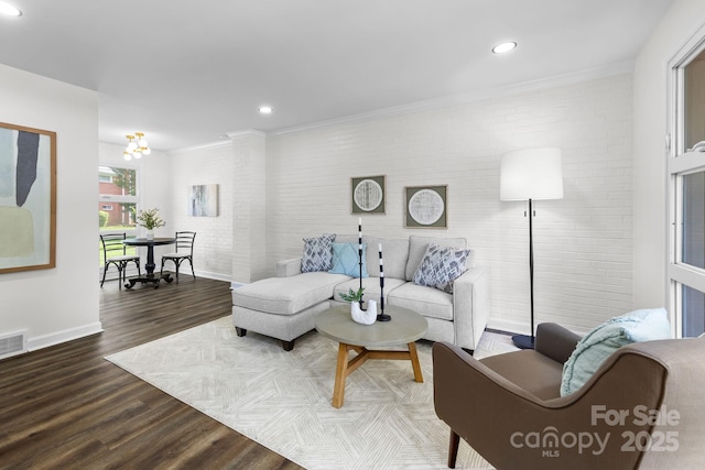 4226 Randolph Rd, Charlotte, NC 28211 - living room with wood finished floors, baseboards, recessed lighting, crown molding, and brick wall