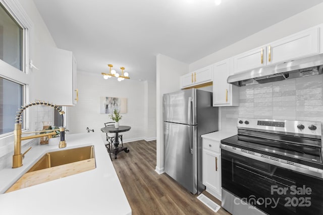 4226 Randolph Rd, Charlotte, NC 28211 - kitchen featuring stainless steel appliances, under cabinet range hood, light countertops, and white cabinetry