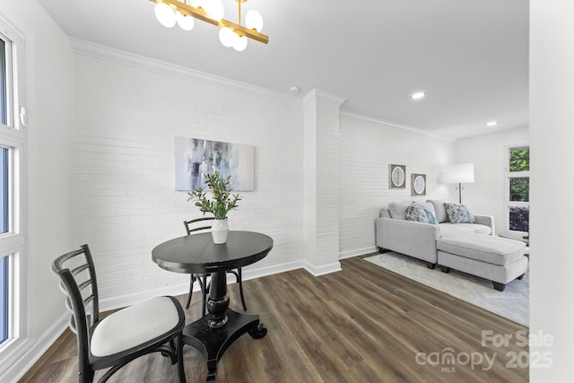 4226 Randolph Rd, Charlotte, NC 28211 - bedroom with brick wall, dark wood finished floors, crown molding, baseboards, and a chandelier