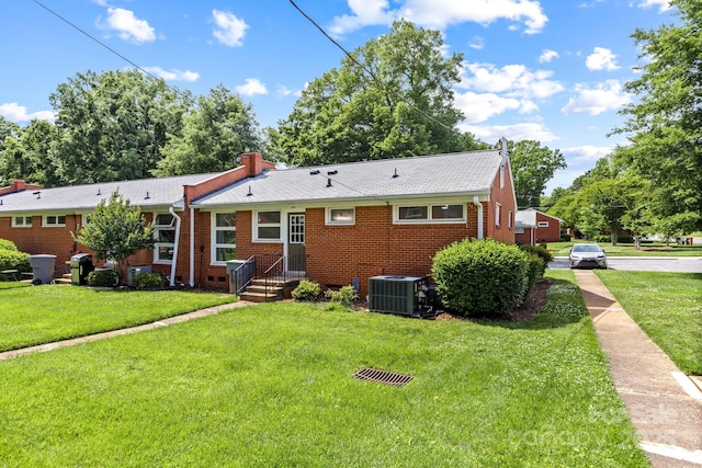 4226 Randolph Rd, Charlotte, NC 28211 - back of house featuring central AC unit, brick siding, and a yard