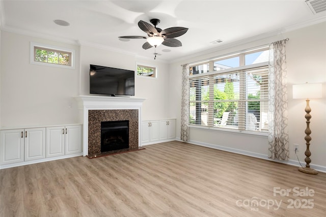 10502 Old Ardrey Kell Rd, Charlotte, NC 28277 - unfurnished living room featuring crown molding, light wood-style floors, baseboards, a high end fireplace, and ceiling fan