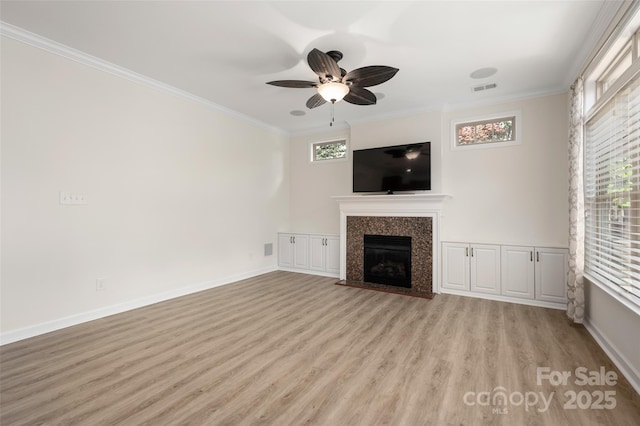 10502 Old Ardrey Kell Rd, Charlotte, NC 28277 - unfurnished living room with light wood-type flooring, ornamental molding, a fireplace with flush hearth, ceiling fan, and baseboards