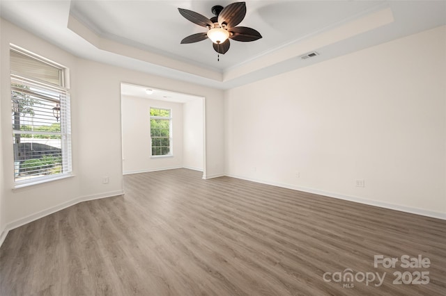 10502 Old Ardrey Kell Rd, Charlotte, NC 28277 - unfurnished room with a tray ceiling, ornamental molding, wood finished floors, ceiling fan, and baseboards