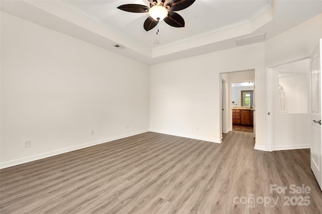 10502 Old Ardrey Kell Rd, Charlotte, NC 28277 - spare room with wood finished floors, crown molding, a raised ceiling, ceiling fan, and baseboards