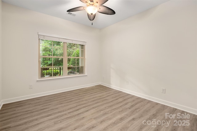 10502 Old Ardrey Kell Rd, Charlotte, NC 28277 - unfurnished room with wood finished floors, baseboards, and a ceiling fan