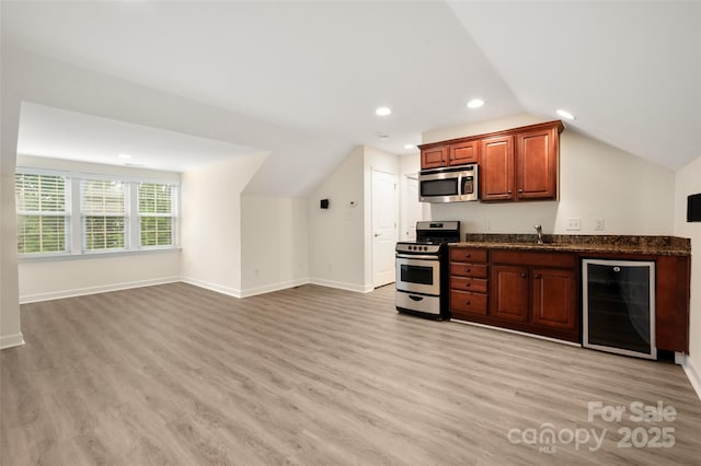 10502 Old Ardrey Kell Rd, Charlotte, NC 28277 - indoor wet bar featuring wine cooler, appliances with stainless steel finishes, light wood-style flooring, lofted ceiling, and baseboards