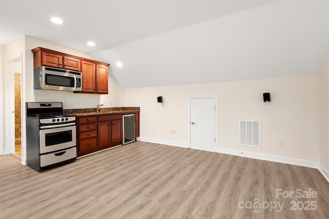 10502 Old Ardrey Kell Rd, Charlotte, NC 28277 - kitchen with stainless steel appliances, wine cooler, light wood-style flooring, lofted ceiling, and brown cabinetry