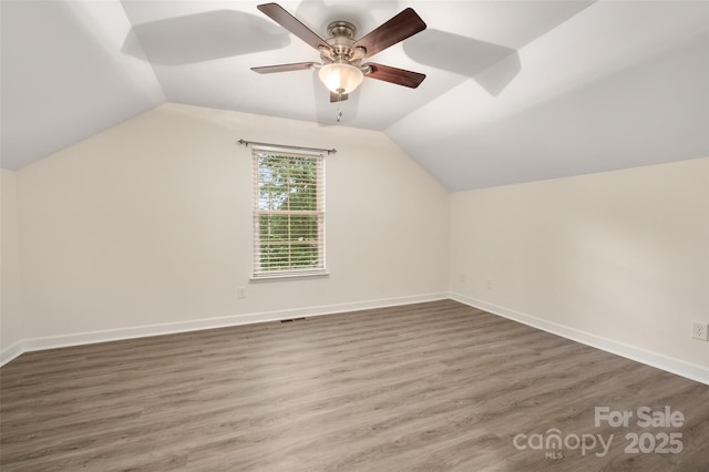 10502 Old Ardrey Kell Rd, Charlotte, NC 28277 - bonus room featuring a ceiling fan, lofted ceiling, wood finished floors, and baseboards