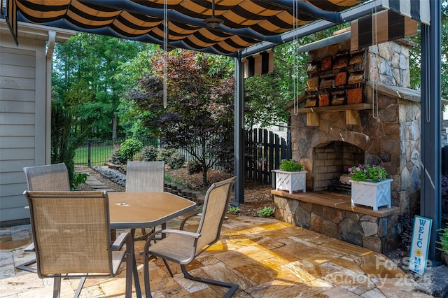 10502 Old Ardrey Kell Rd, Charlotte, NC 28277 - view of patio / terrace featuring an outdoor stone fireplace, outdoor dining space, and fence