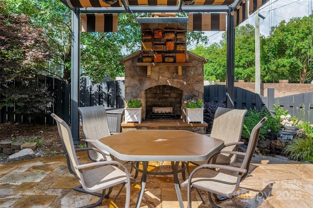 10502 Old Ardrey Kell Rd, Charlotte, NC 28277 - view of patio featuring an outdoor stone fireplace, outdoor dining area, and a fenced backyard