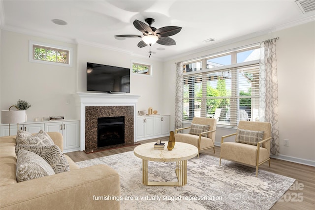 10502 Old Ardrey Kell Rd, Charlotte, NC 28277 - living room with ornamental molding, light wood-style flooring, healthy amount of natural light, and a fireplace