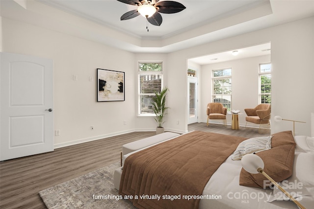 10502 Old Ardrey Kell Rd, Charlotte, NC 28277 - bedroom with crown molding, wood finished floors, a raised ceiling, and multiple windows