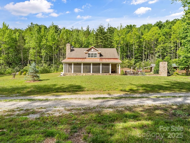 4290 Black Bear Trl, Morganton, NC 28655 - back of house with a sunroom, a wooded view, metal roof, a yard, and a chimney