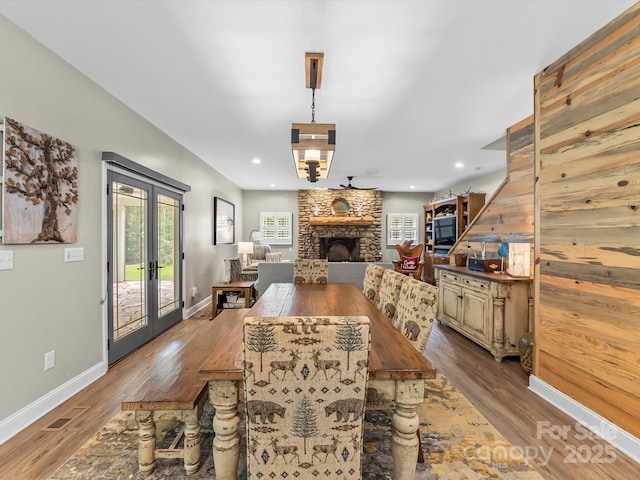 4290 Black Bear Trl, Morganton, NC 28655 - dining space featuring baseboards, wood finished floors, french doors, recessed lighting, and a stone fireplace