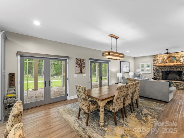 4290 Black Bear Trl, Morganton, NC 28655 - dining room with french doors, light wood-style flooring, a fireplace, plenty of natural light, and recessed lighting