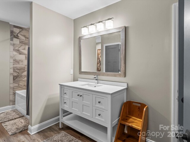 4290 Black Bear Trl, Morganton, NC 28655 - bathroom featuring wood finished floors, vanity, baseboards, and shower / washtub combination