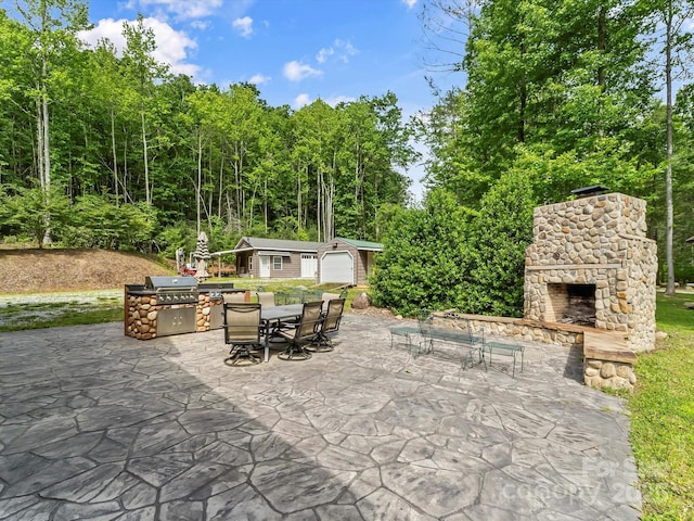 4290 Black Bear Trl, Morganton, NC 28655 - view of patio / terrace featuring an outdoor stone fireplace, outdoor dining space, an outdoor structure, a view of trees, and area for grilling