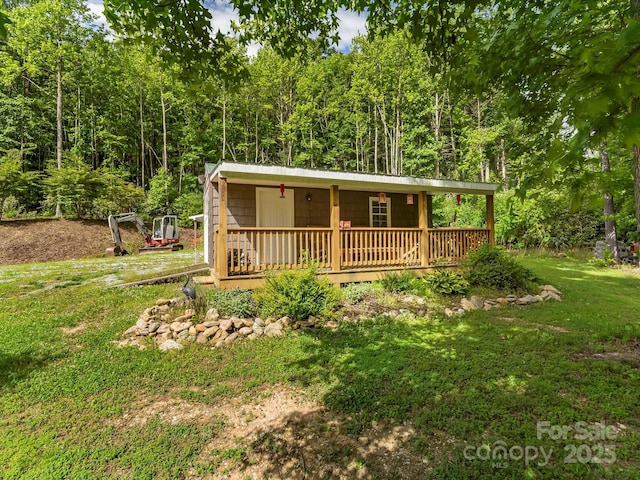 4290 Black Bear Trl, Morganton, NC 28655 - view of front facade featuring a front lawn, a forest view, and a porch