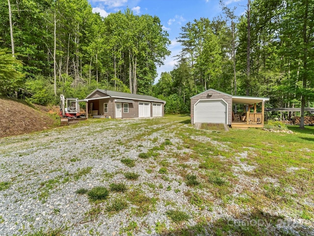 4290 Black Bear Trl, Morganton, NC 28655 - view of grassy yard with an outbuilding, a detached garage, a wooden deck, and a wooded view
