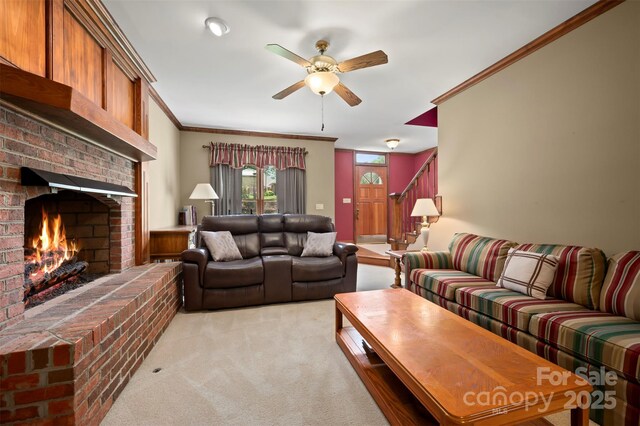 312 Briarwood Dr, Rutherfordton, NC 28139 - living area with light colored carpet, ceiling fan, a fireplace, ornamental molding, and stairway