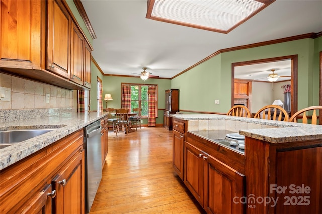 312 Briarwood Dr, Rutherfordton, NC 28139 - kitchen with ceiling fan, dishwasher, light wood-style floors, brown cabinets, and ornamental molding