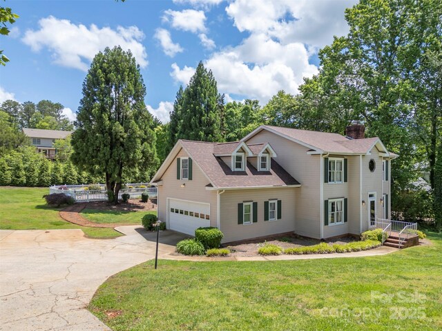 312 Briarwood Dr, Rutherfordton, NC 28139 - view of front of home featuring concrete driveway, a chimney, a garage, and a shingled roof