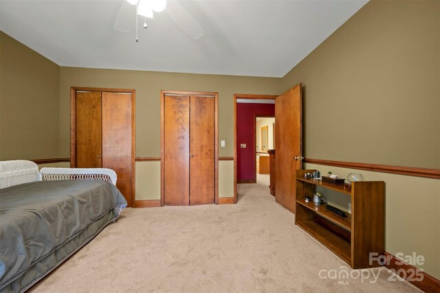 312 Briarwood Dr, Rutherfordton, NC 28139 - bedroom featuring light colored carpet, two closets, ceiling fan, and baseboards