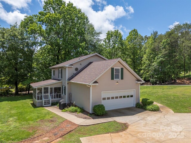 312 Briarwood Dr, Rutherfordton, NC 28139 - traditional-style home featuring concrete driveway, a sunroom, a front lawn, and a shingled roof