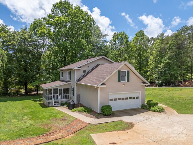 312 Briarwood Dr, Rutherfordton, NC 28139 - traditional-style house featuring a sunroom, driveway, roof with shingles, and a front yard